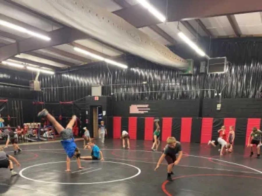 ECKWC athletes practicing movement drills in the wrestling room