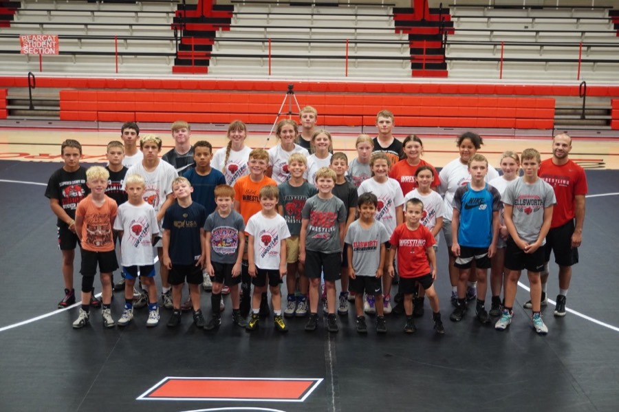 Group of Ellsworth wrestlers and coaches standing together on the mat